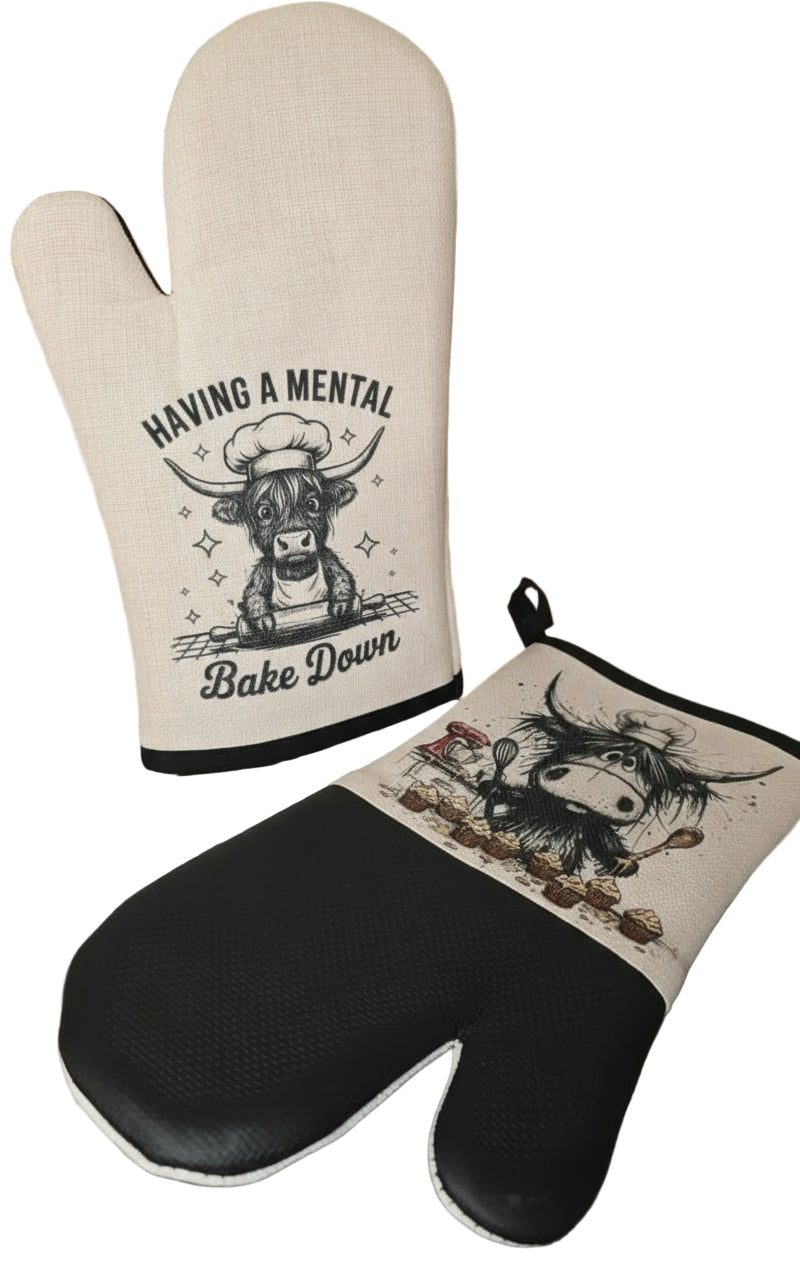 Oven mitt and pot holder set with cow design on a gray surface