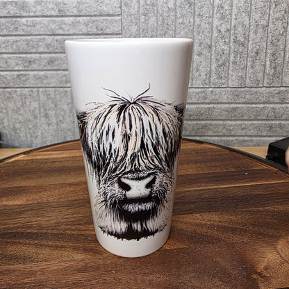 Latte Mug with a black and white Highland Cow design on a wooden table